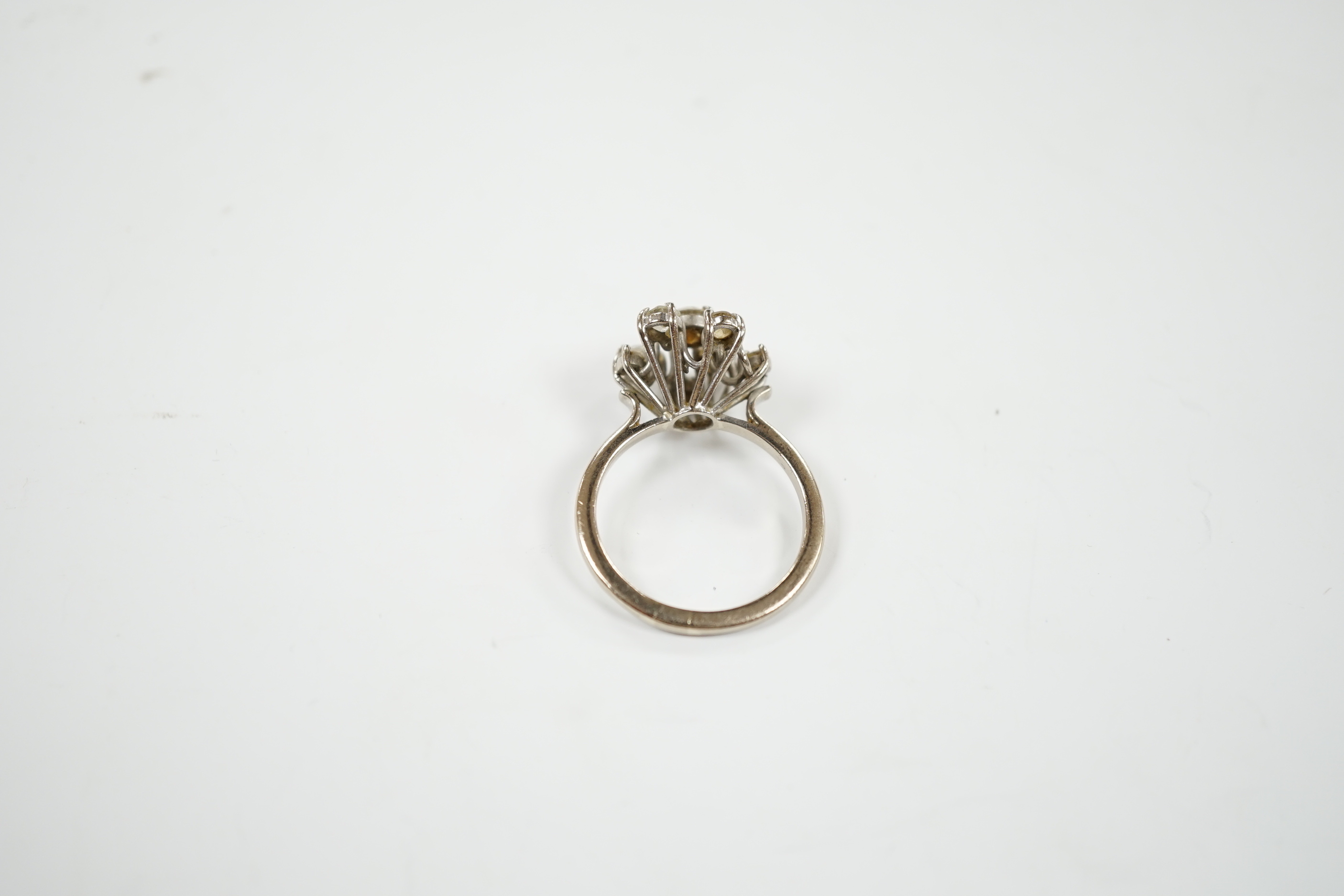 A modern 18ct white gold and graduated eight stone diamond cluster set dress ring, size S, gross weight 7 grams.